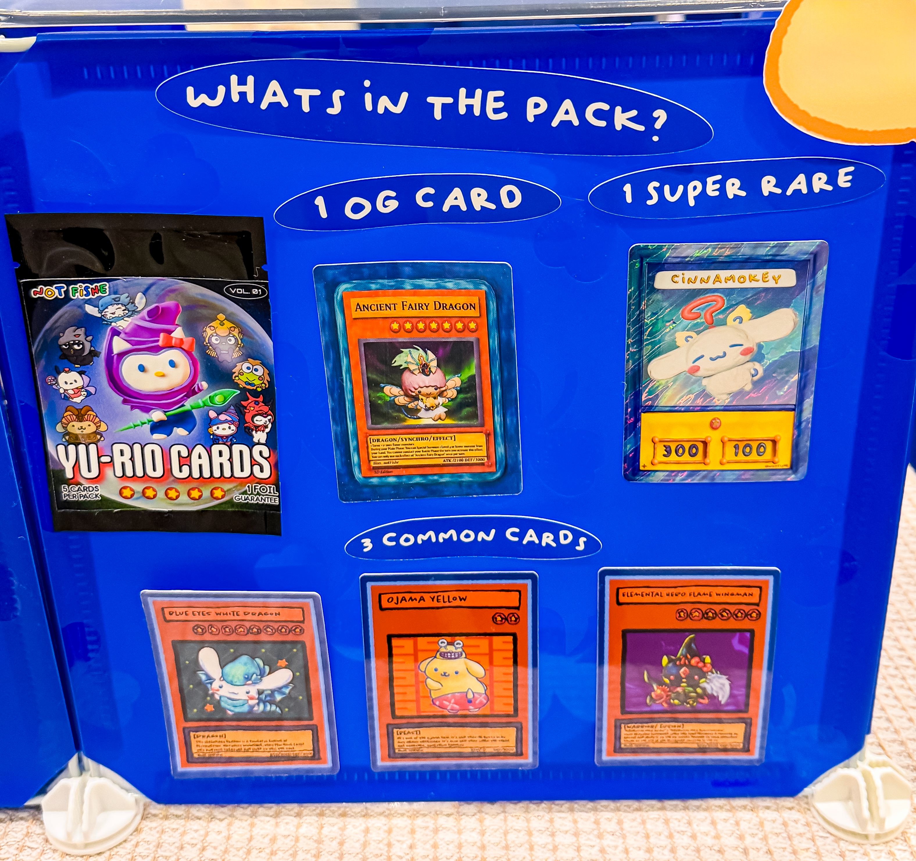 Booth display board showing the contents of a Yu-Rio card pack